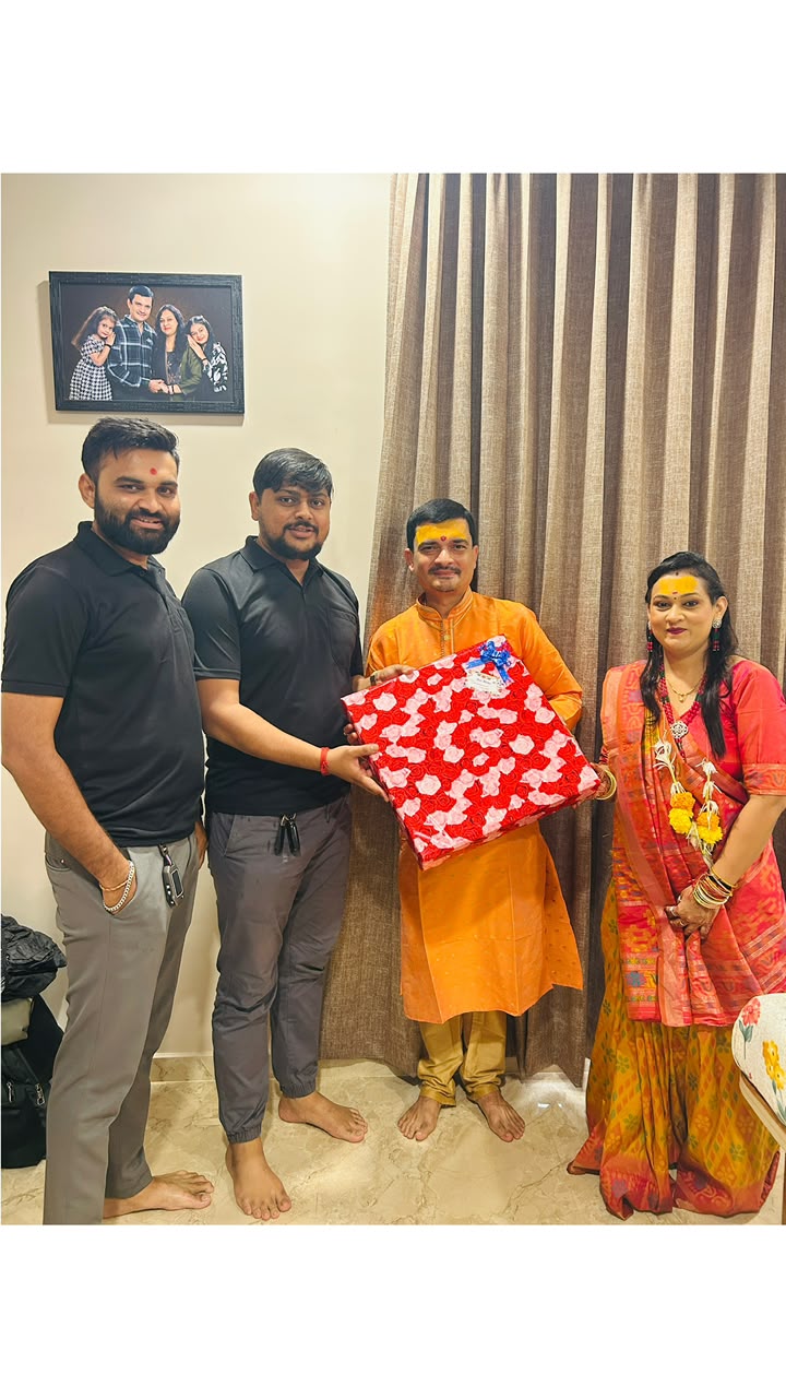 Sarvamangal team sharing a gift with a couple in traditional festive clothing